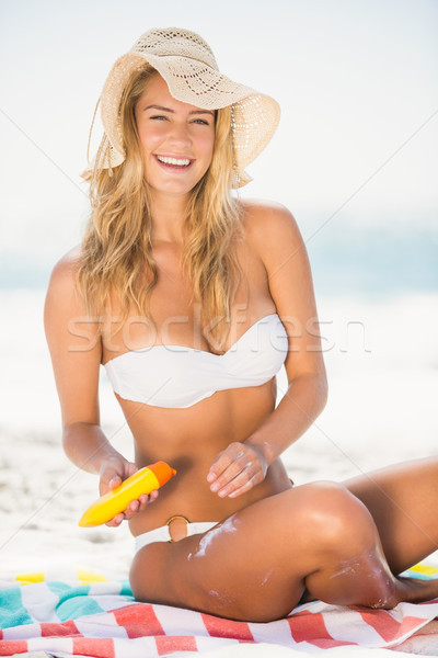 Smiling woman applying sunscreen Stock photo © wavebreak_media