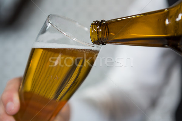Bartender pouring beer in glass Stock photo © wavebreak_media