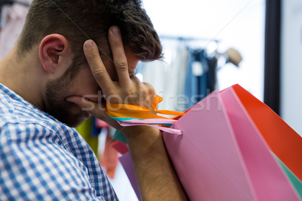 Gelangweilt Mann Einkaufstaschen Frau Kleiderständer Kleidung Stock foto © wavebreak_media