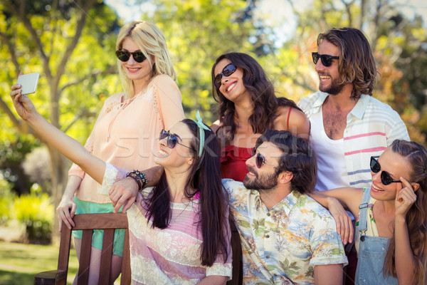 Stock photo: Group of friends taking selfie with mobile phone