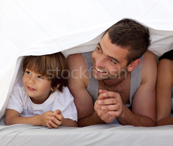 Smiling father and son under the bedsheets Stock photo © wavebreak_media