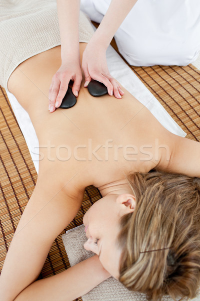 Pretty woman lying on a massage table having a stone therapy Stock photo © wavebreak_media