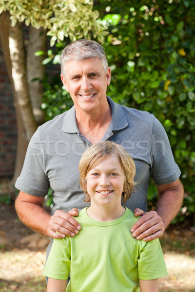 Father and his son looking at the camera in the garden Stock photo © wavebreak_media