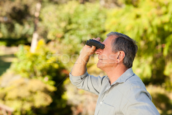 Elderly man looking at the sky with his binoculars Stock photo © wavebreak_media