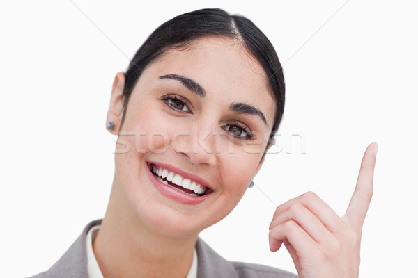 Close up of smiling businesswoman pointing up against a white background Stock photo © wavebreak_media