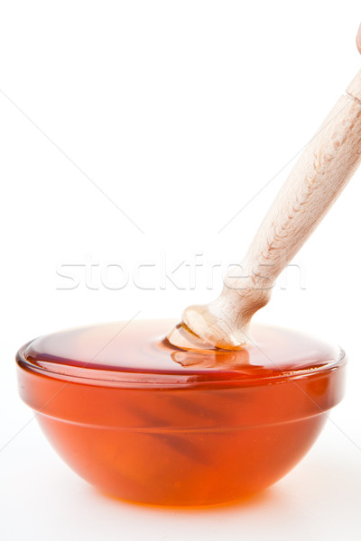 Honey dipper in a honey bowl against a white background Stock photo © wavebreak_media