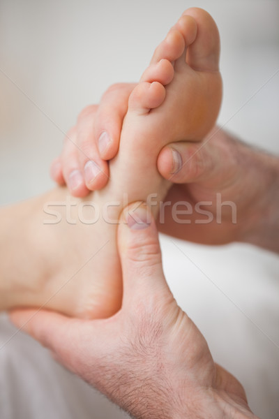 Close-up of two hands massaging a foot in a room Stock photo © wavebreak_media