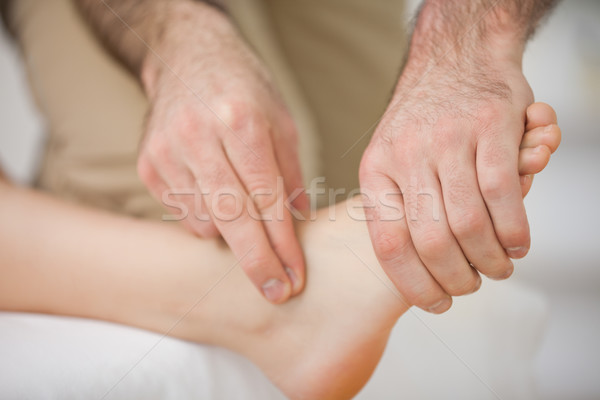Two fingers touching and massaging a foot indoors Stock photo © wavebreak_media