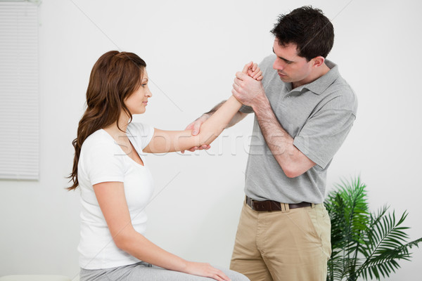 Serious practitioner touching the elbow of a woman in a medical room Stock photo © wavebreak_media