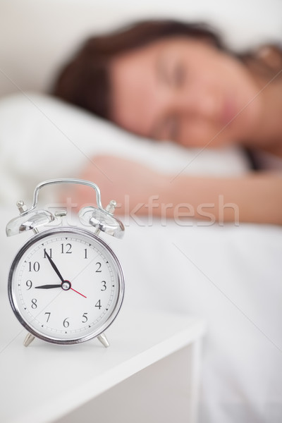 Alarm clock being placed on a bedside table in a bedroom Stock photo © wavebreak_media