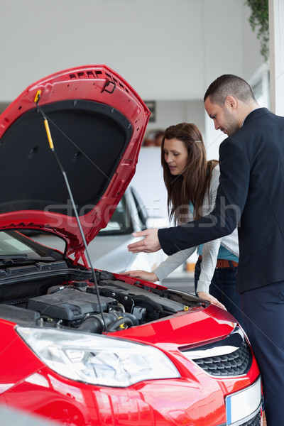 Salesman showing the car engine in a garage Stock photo © wavebreak_media