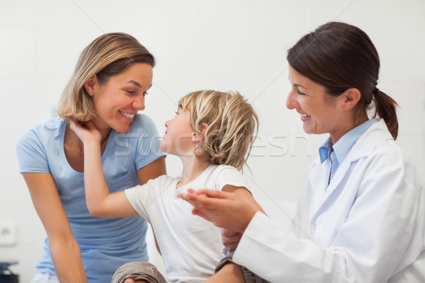 Child and his mother smiling in examination room Stock photo © wavebreak_media