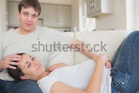 Young woman lying on the lap of husband in lving room on sofa Stock photo © wavebreak_media