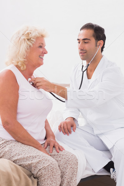 Doctor examining a smiling old woman Stock photo © wavebreak_media