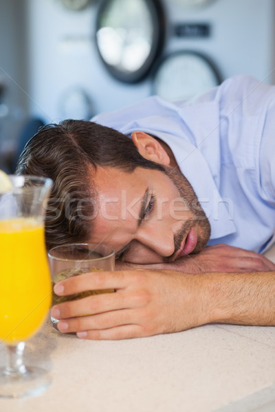 Drunk businessman asleep on bar beside cocktail Stock photo © wavebreak_media