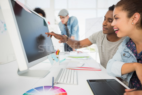 Stock photo: Casual photo editors using graphics tablet