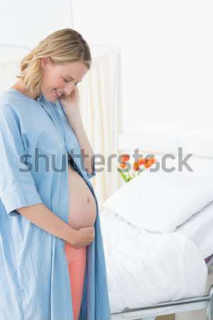 Happy pregnant woman wearing hospital gown  Stock photo © wavebreak_media