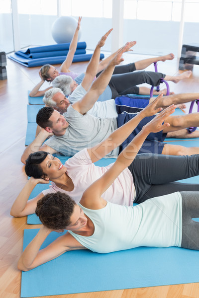 Fitness class stretching legs and hands in row Stock photo © wavebreak_media