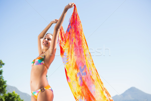 Beautiful brunette in bikini holding sarong up Stock photo © wavebreak_media