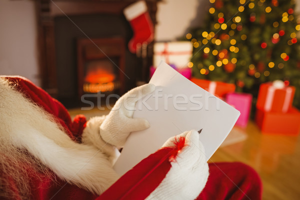 Stock photo: Santa claus writing list with a quill