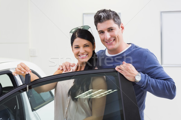 Smiling couple holding their new car key Stock photo © wavebreak_media