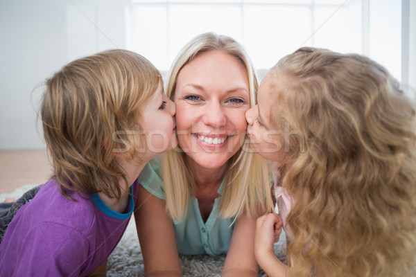 Happy woman being kissed by children Stock photo © wavebreak_media