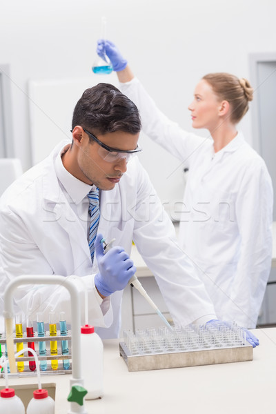 Scientists examining tubes and baker   Stock photo © wavebreak_media