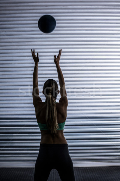 Muscular woman throwing ball in the air Stock photo © wavebreak_media