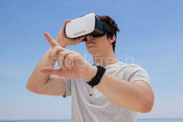 Man using vr headset against the blue sky Stock photo © wavebreak_media