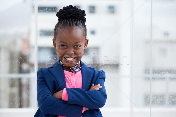 Portrait of cheerful businesswoman standing with arms crossed by window Stock photo © wavebreak_media