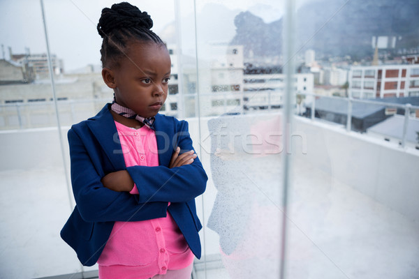 Serious thoughtful businesswoman standing with arms crossed Stock photo © wavebreak_media