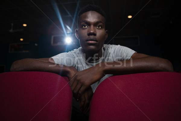 Concentrated man watching movie in theatre Stock photo © wavebreak_media