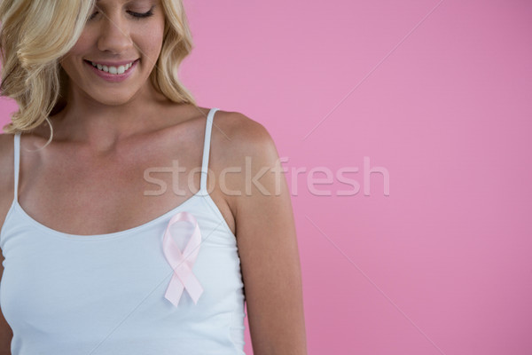Smiling woman with Breast Cancer Awareness ribbon Stock photo © wavebreak_media