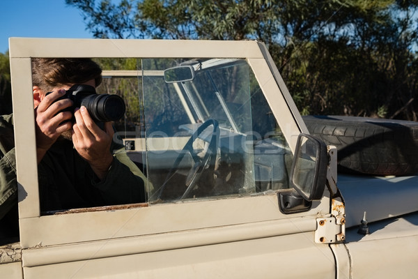 Man photographing while sitting in off road vehicle Stock photo © wavebreak_media