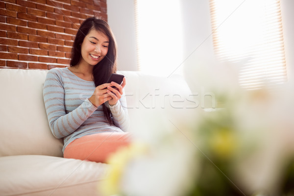 Stock photo: Asian woman reading text on couch