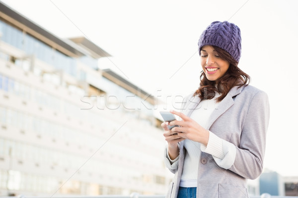Smiling woman using mobile phone  Stock photo © wavebreak_media