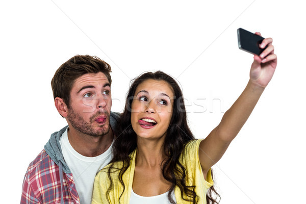 Couple sticking out tongue while taking selfie  Stock photo © wavebreak_media