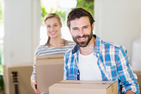 Portrait of young couple holding cardboard boxes Stock photo © wavebreak_media