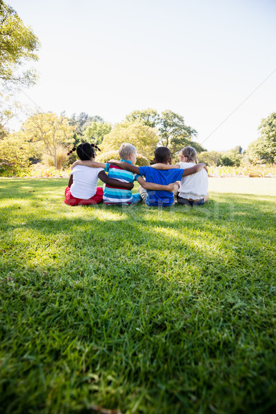 Enfants séance herbe ensemble parc [[stock_photo]] © wavebreak_media