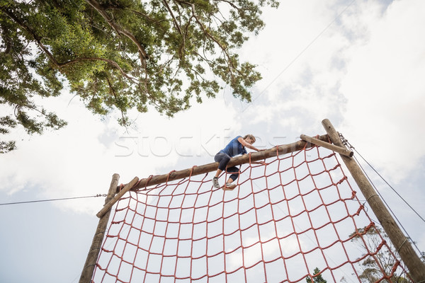 Fit woman climbing a net during obstacle course Stock photo © wavebreak_media