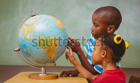 Composite image of pupil studying the globe Stock photo © wavebreak_media