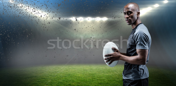Composite image of portrait of confident athlete standing with rugby ball Stock photo © wavebreak_media