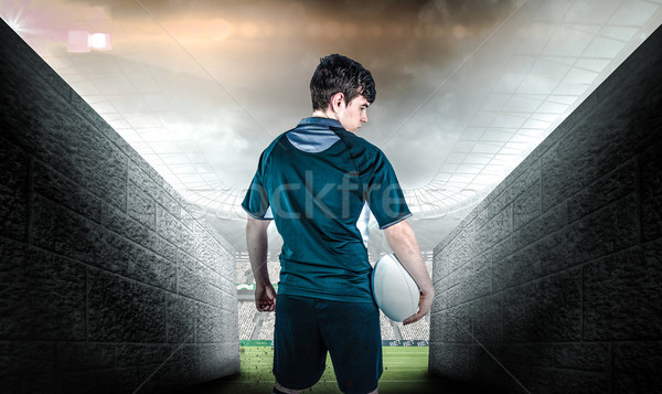 Composite image of back turned rugby player holding a ball Stock photo © wavebreak_media