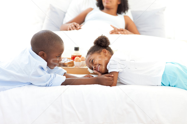 Loving Family Having Breakfast In The Bedroom Stock Photo