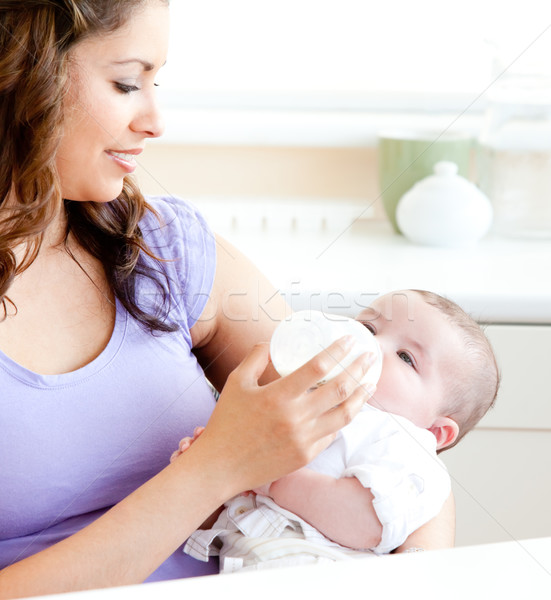 Radiant mother feeding her adorable son in the kitchen at home Stock photo © wavebreak_media