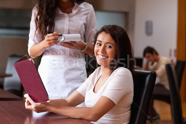 Smiling woman ordering a meal in a restaurant Stock photo © wavebreak_media