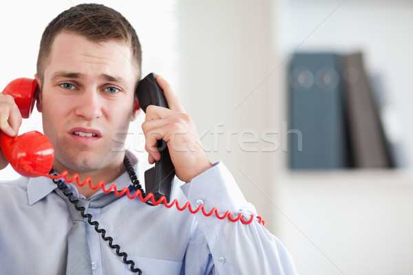 Stock photo: Stressed businessman troubled by the telephone