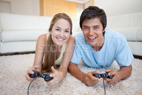 Smiling couple playing video games in their living room Stock photo © wavebreak_media