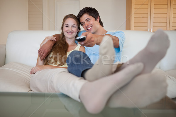 Relaxed lovely couple watching television in their living room Stock photo © wavebreak_media