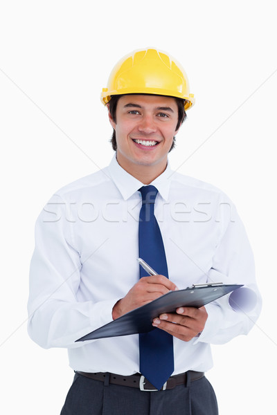 Smiling male architect with clipboard and pen against a white background Stock photo © wavebreak_media